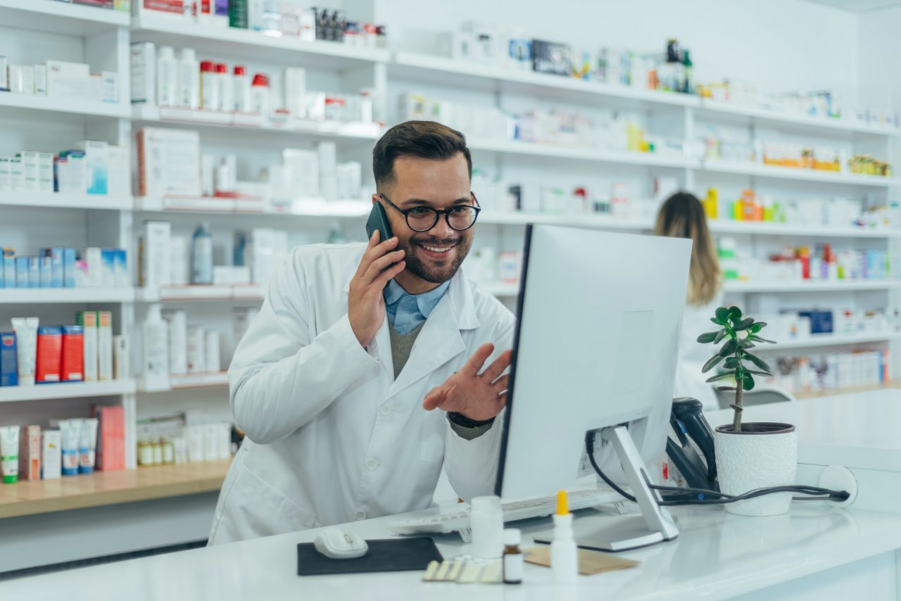 portrait of a handsome pharmacist working in a pharmacy